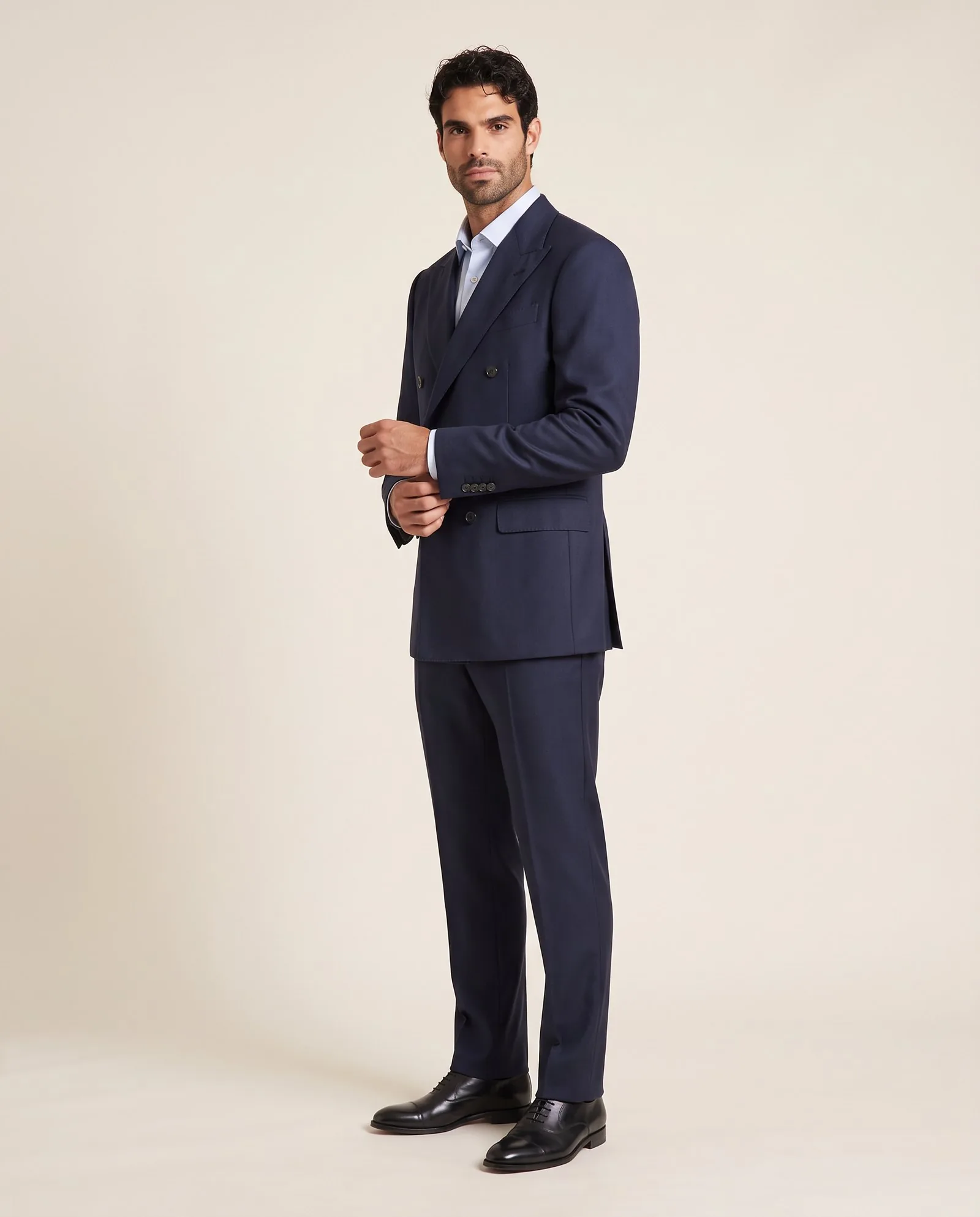 Model in a tailored navy blazer and trousers